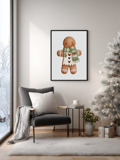 Framed gingerbread man print on a wall in a cozy living room with a Christmas tree.