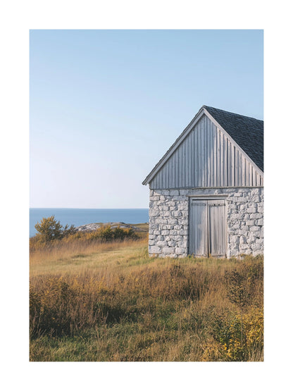 Poster of a weathered stone barn on Gotland with sea in the background