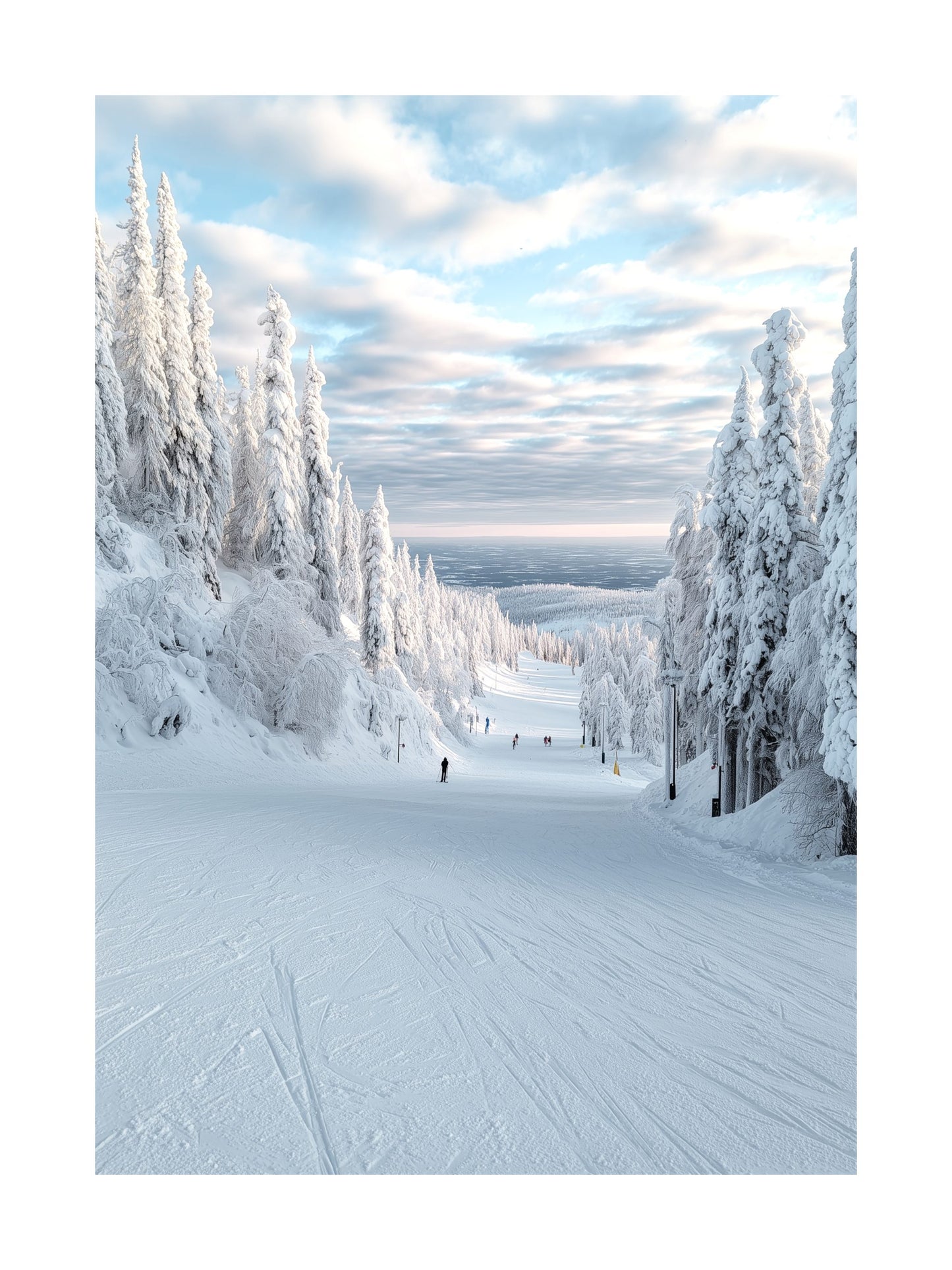 Wide ski slope surrounded by snow-covered trees under a blue sky.