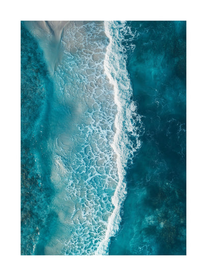 Aerial shot of sea waves rolling onto a sandy beach with stunning clarity. Ideal for wall art in your home, office, or studio.