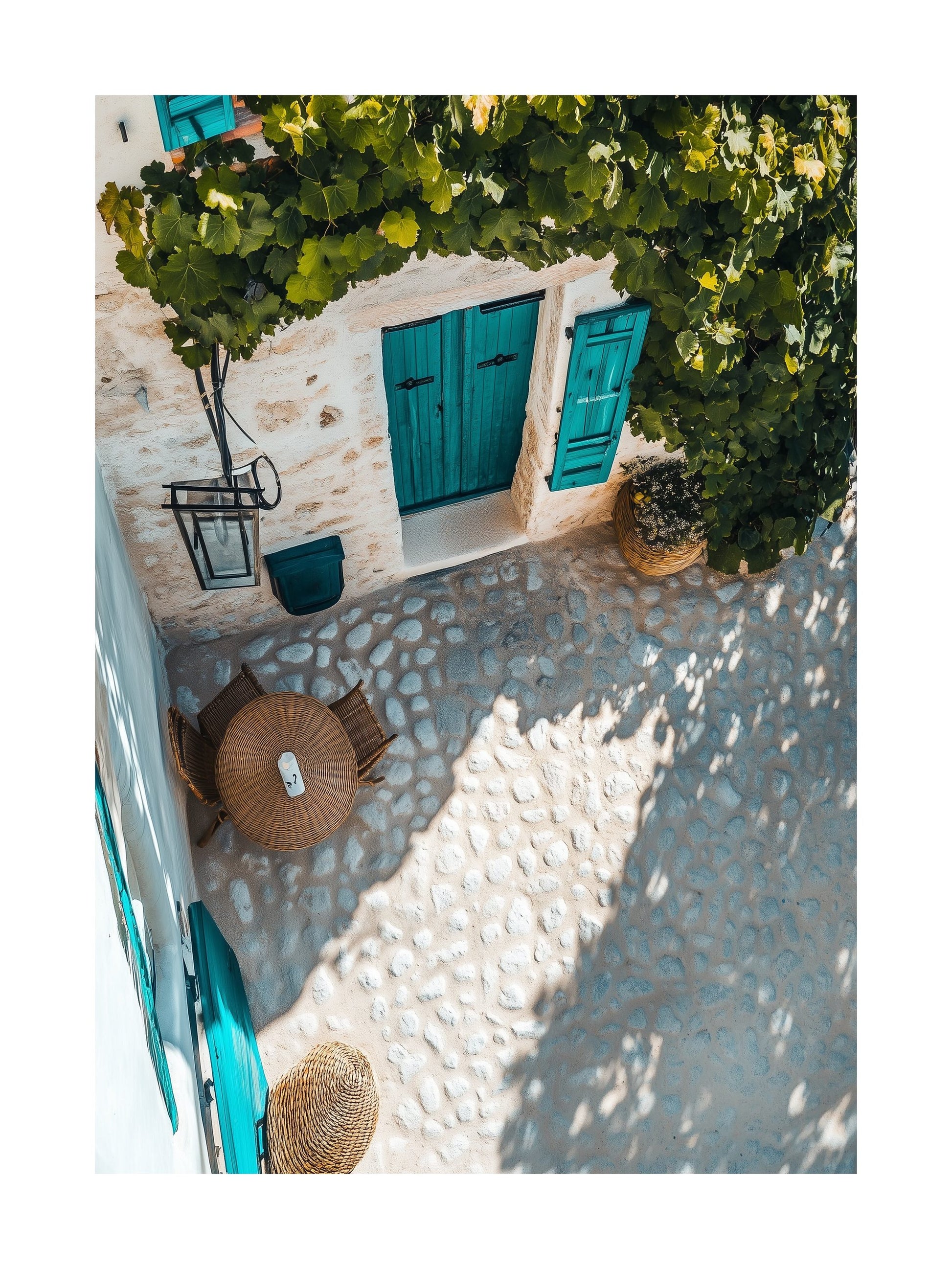 Overhead view of a Mediterranean courtyard with blue doors, vine shade, and stone pavement. Ideal for wall art in your home, office, or studio.