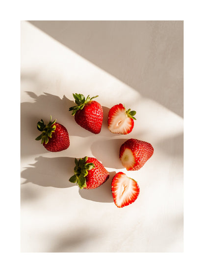 Poster of halved and whole strawberries casting shadows on white