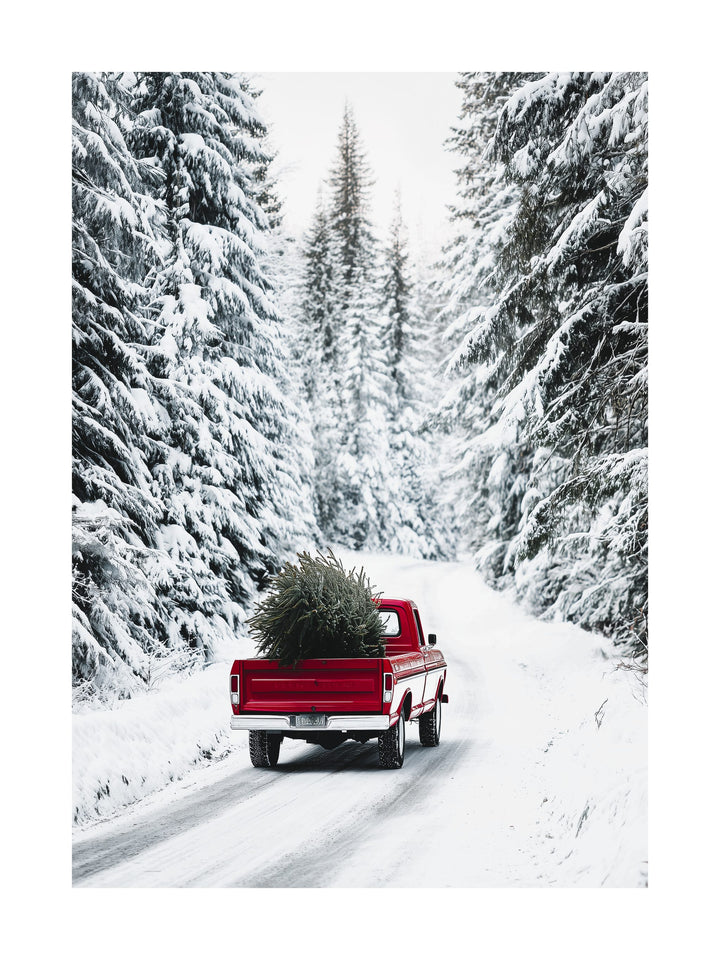 Vintage red pickup truck carrying Christmas tree through snow