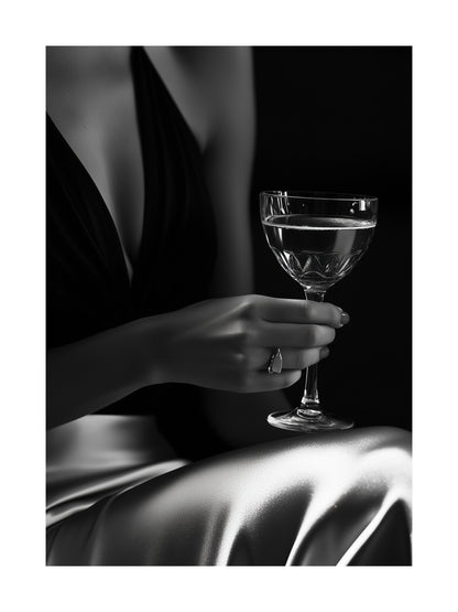 Black and white photo of a woman's hand holding a champagne glass