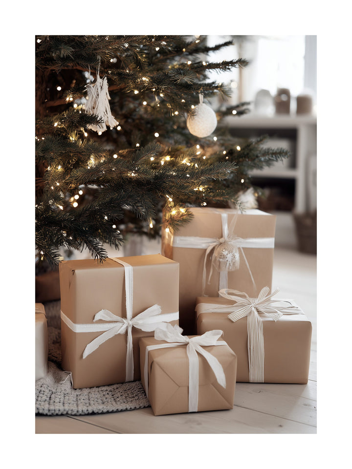 Neatly wrapped Christmas presents under a decorated tree with warm lights