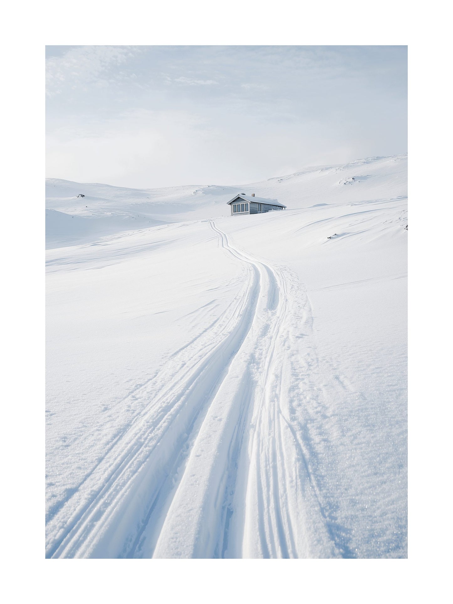 Snowy landscape with ski tracks leading to a small cabin in the distance.