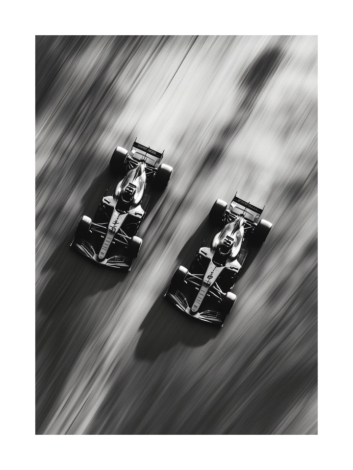 Black and white top-down image of two Formula 1 cars racing