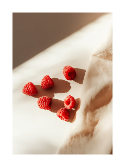 Poster showing raspberries on beige fabric in warm sunlight